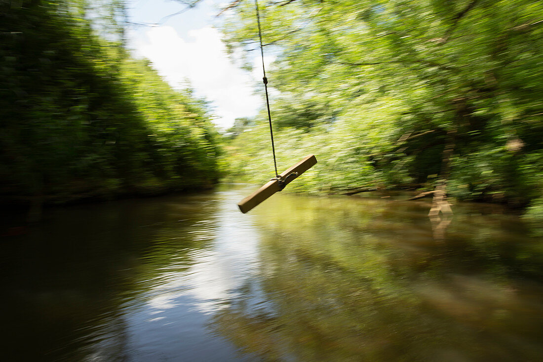 Rope swing swinging above a river