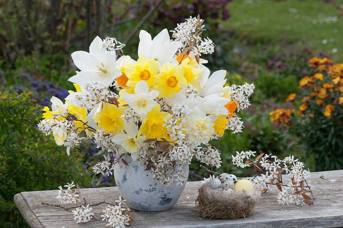 Easter bouquet of daffodils and shadbush, Easter eggs in a nest