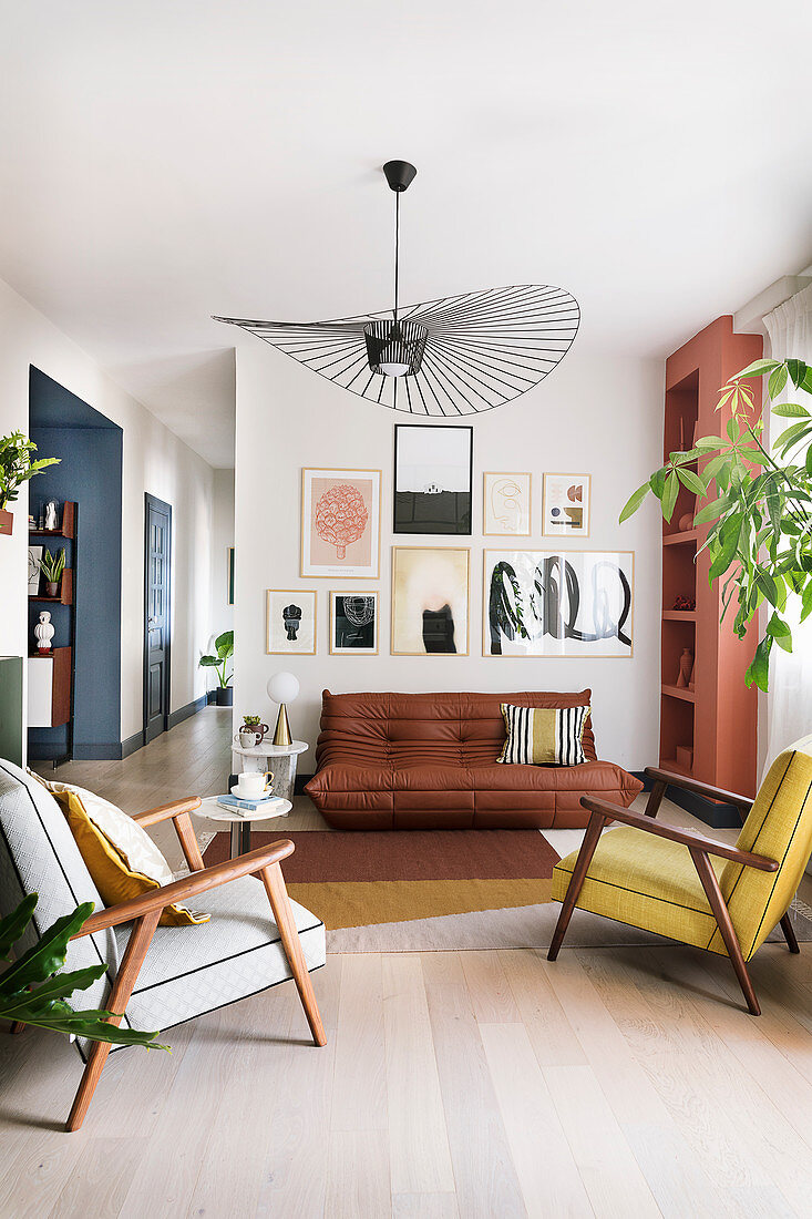 Gallery of pictures in open-plan living room in muted shades