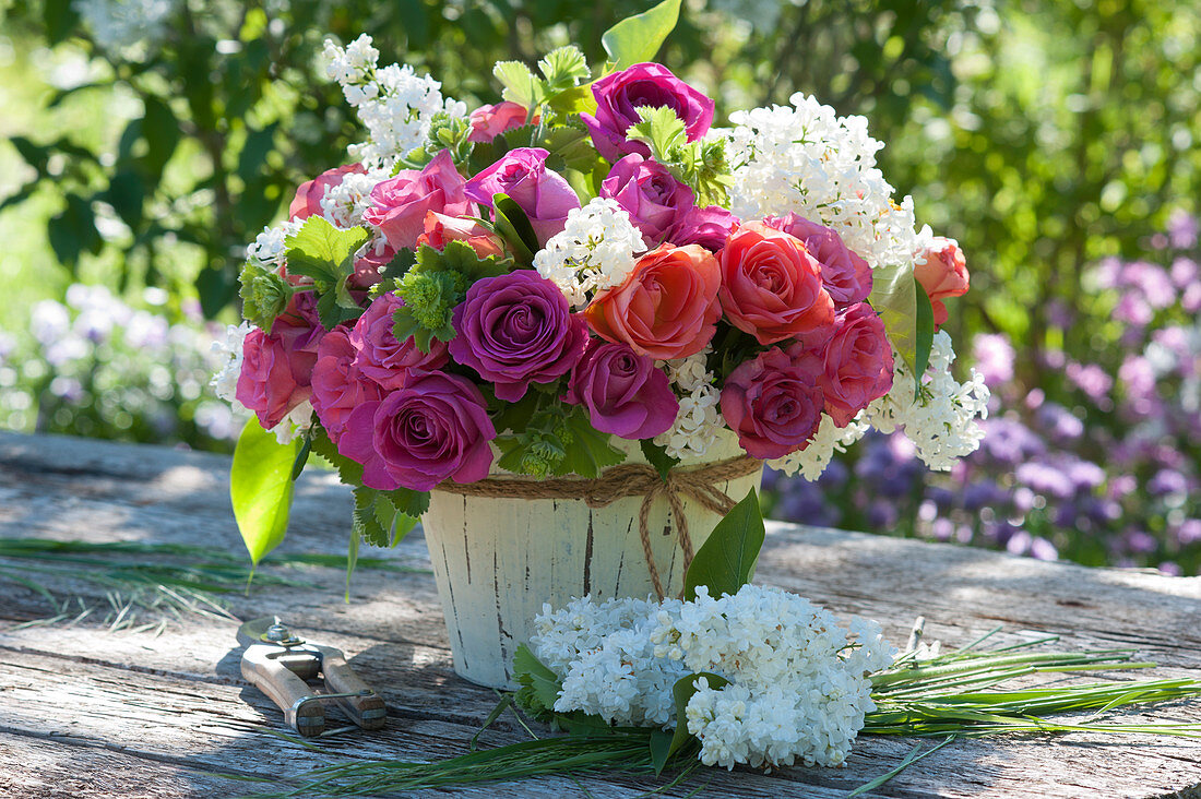 Fragrant bouquet of roses, lilacs, and lady's mantle