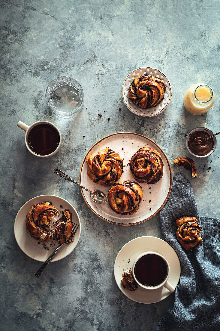 Chocolate babka knots and coffee on a breakfast table