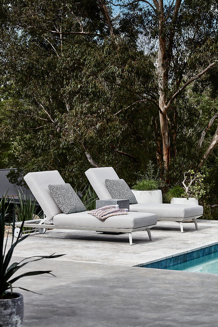 Comfortable loungers next to swimming pool