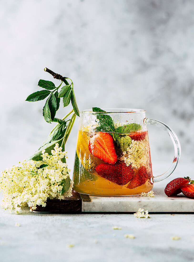 Elderflower syrup with strawberries and mint