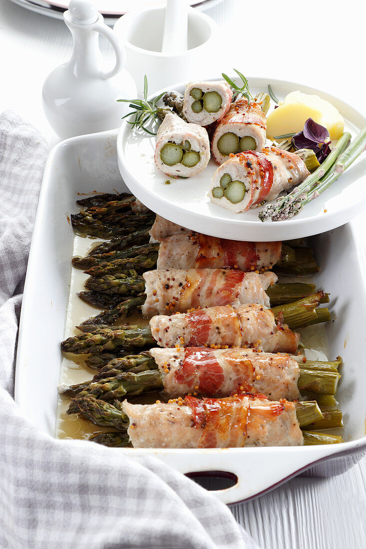 Asparagus rolls baked in chicken fillet and bacon