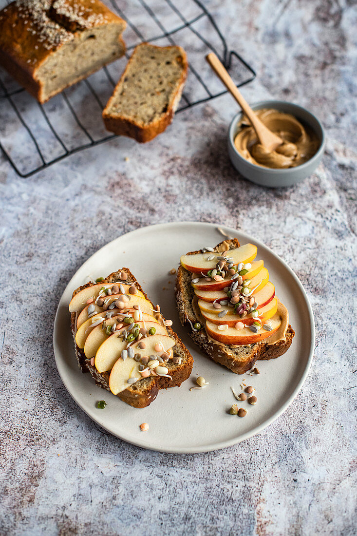 Banana Bread Slices with Peanut Butter, Apple Slices and Sprouts