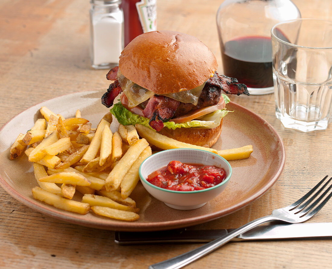 Burger and chips - Beef pattie with bacon, melted cheese and salad, in a brioche bun