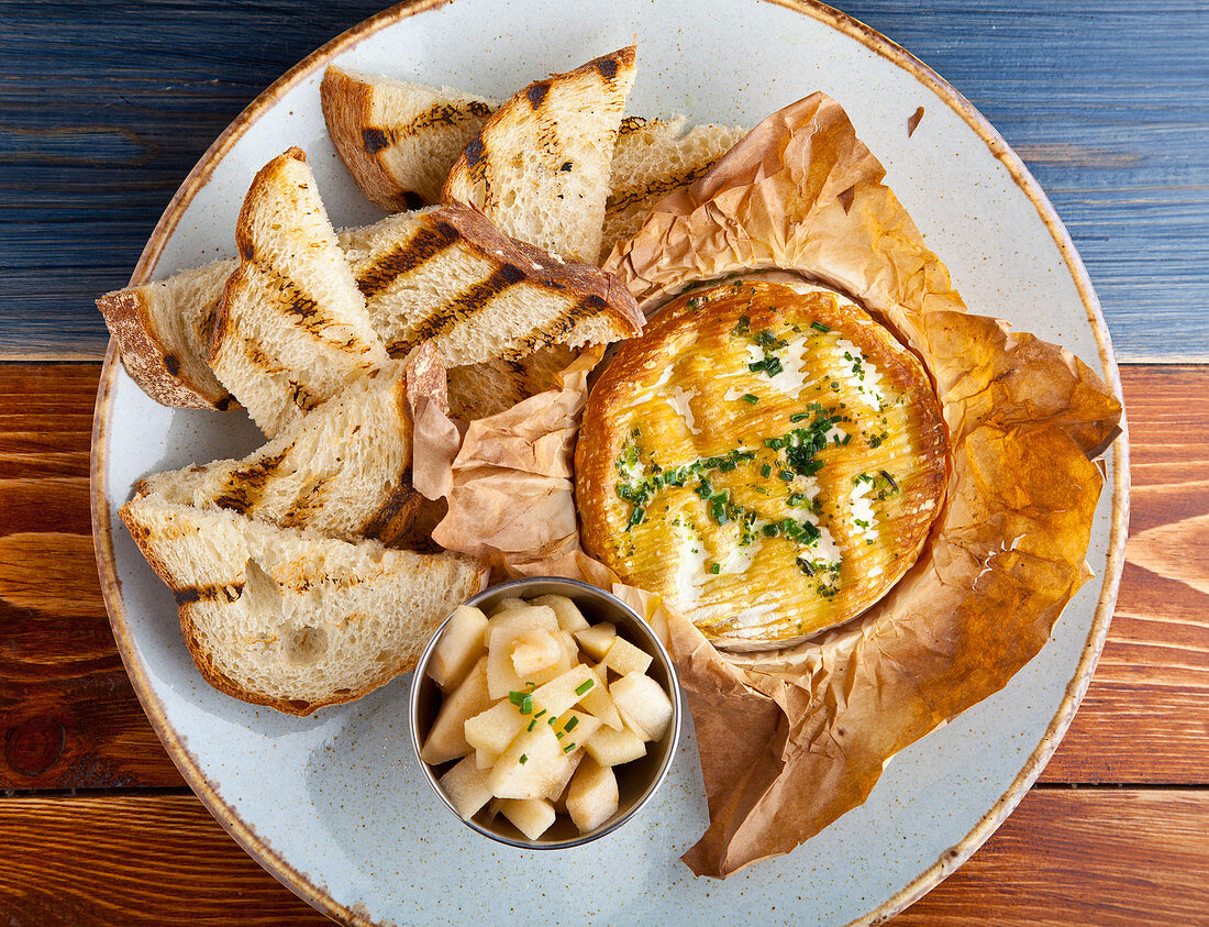 Baked camembert cheese, with toast triangles and a compot of apple
