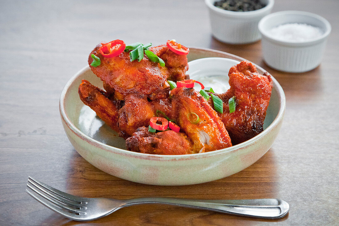Crispy, spicy chicken wings with chilli and spring onion and yogurt dip