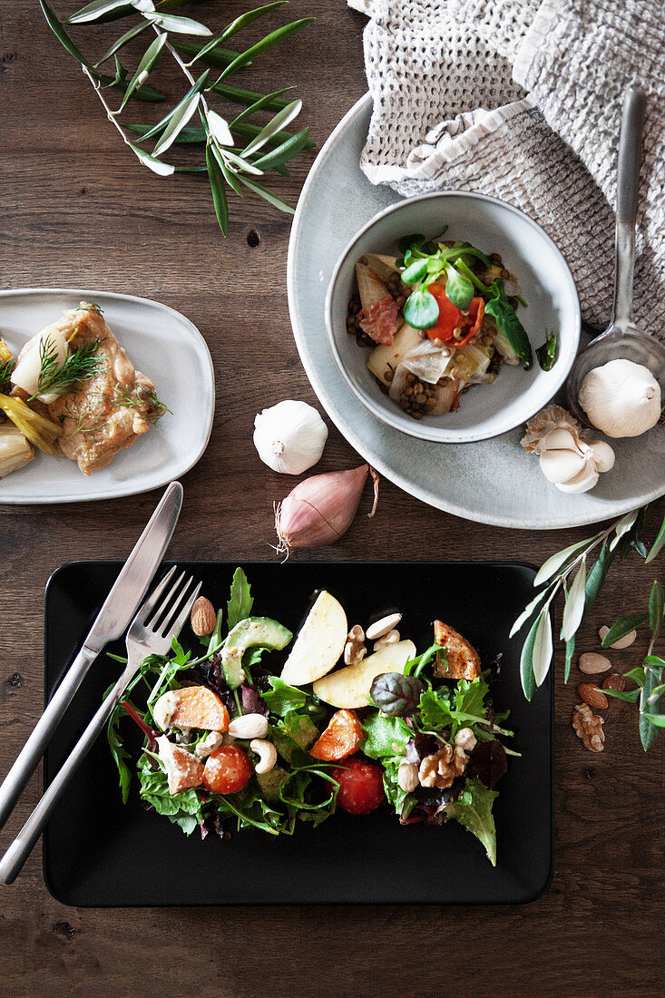 Salad on a black plate and in a bowl