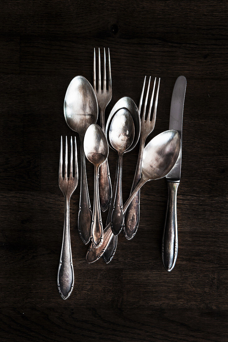 Tarnished silver cutlery - table knives, forks and spoons