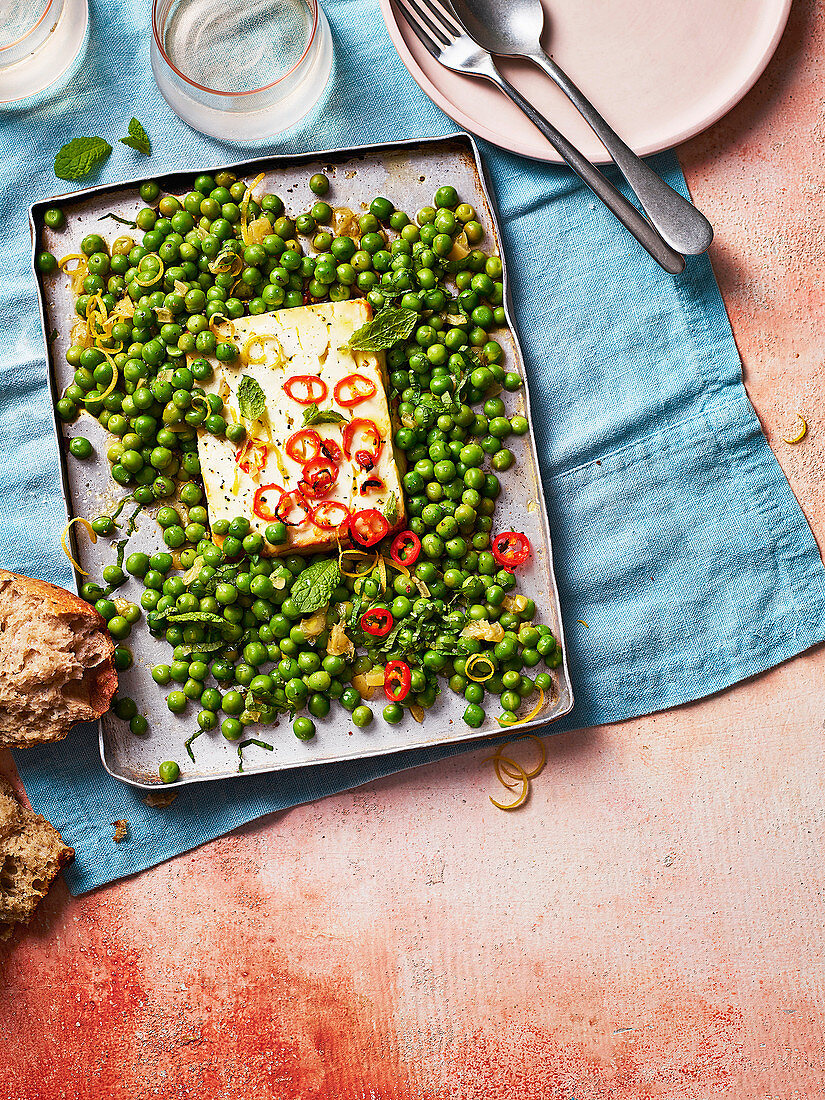 Baked feta with peas, chilli and preserved lemon