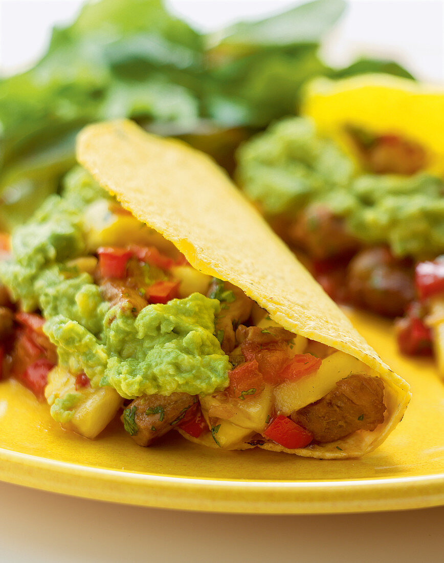 Tacos al pastor with pork, pineapple salsa, and guacamole