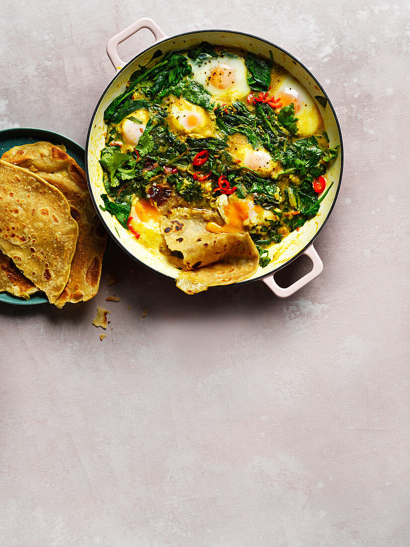 Spinach, coconut and turmeric baked eggs with paratha