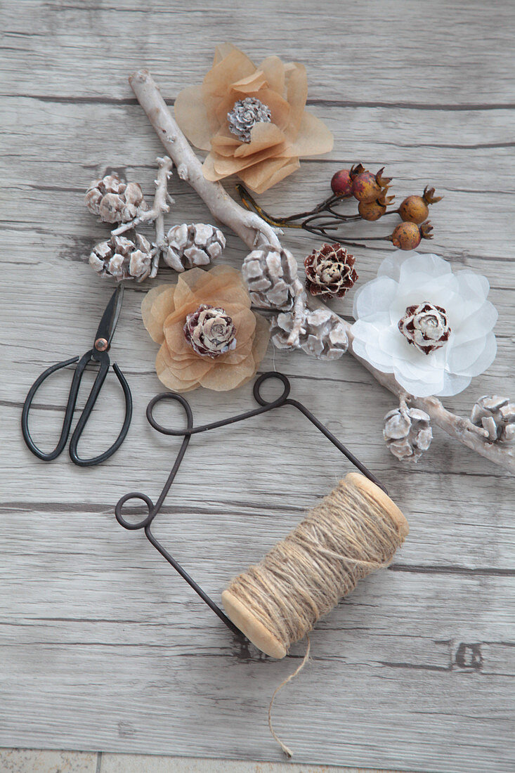 Flowers made of parchment paper with small cones, scissors and string