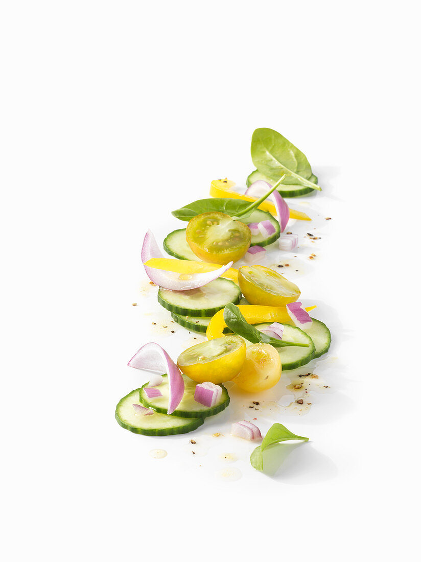 Cucumber salad with red onions and yellow tomato