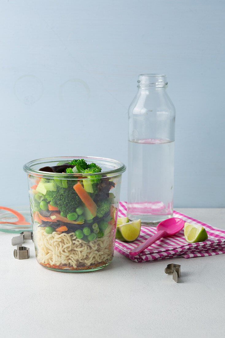 Vegetarian Asian vegetables with noodles in a jar 'To Go'