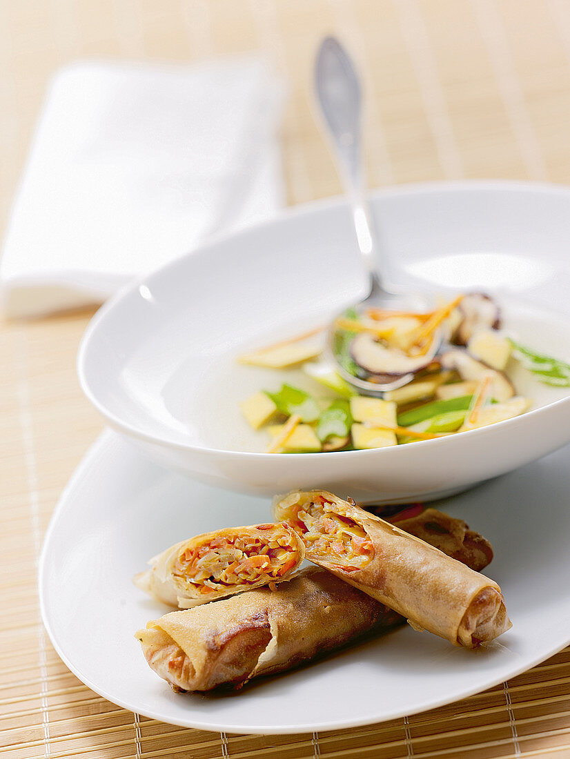Asian vegetable egg drop soup served with spring rolls