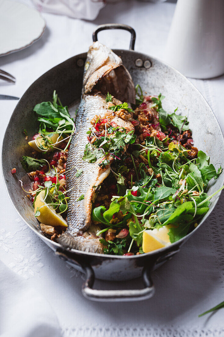 Baked sea bass with a walnut and pomegranate filling