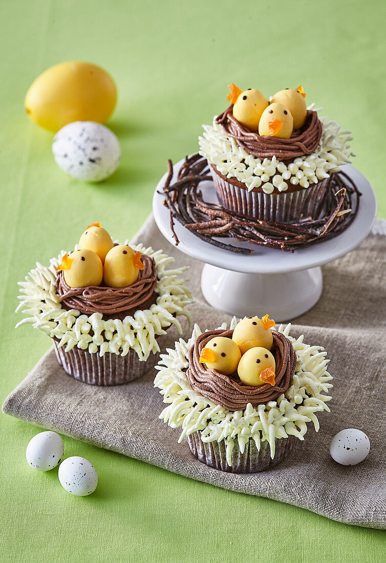 Cocoa cupcakes decorated as Easter nests with chicks