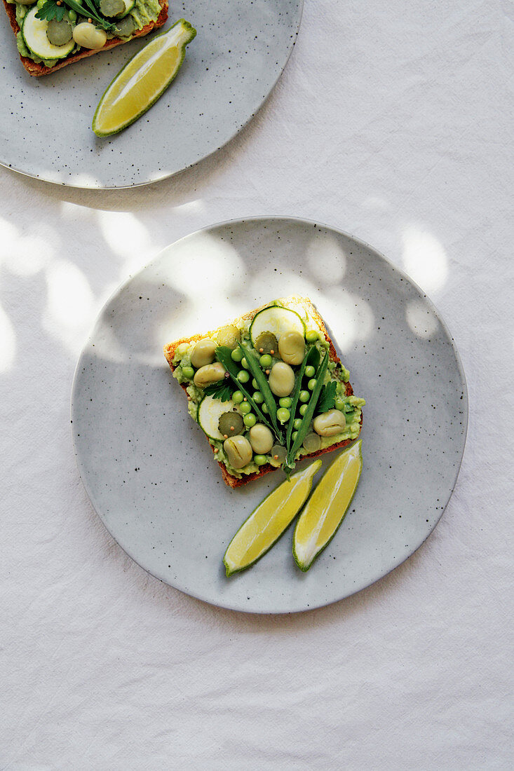 Crispy avocado toast with broad beans and peas