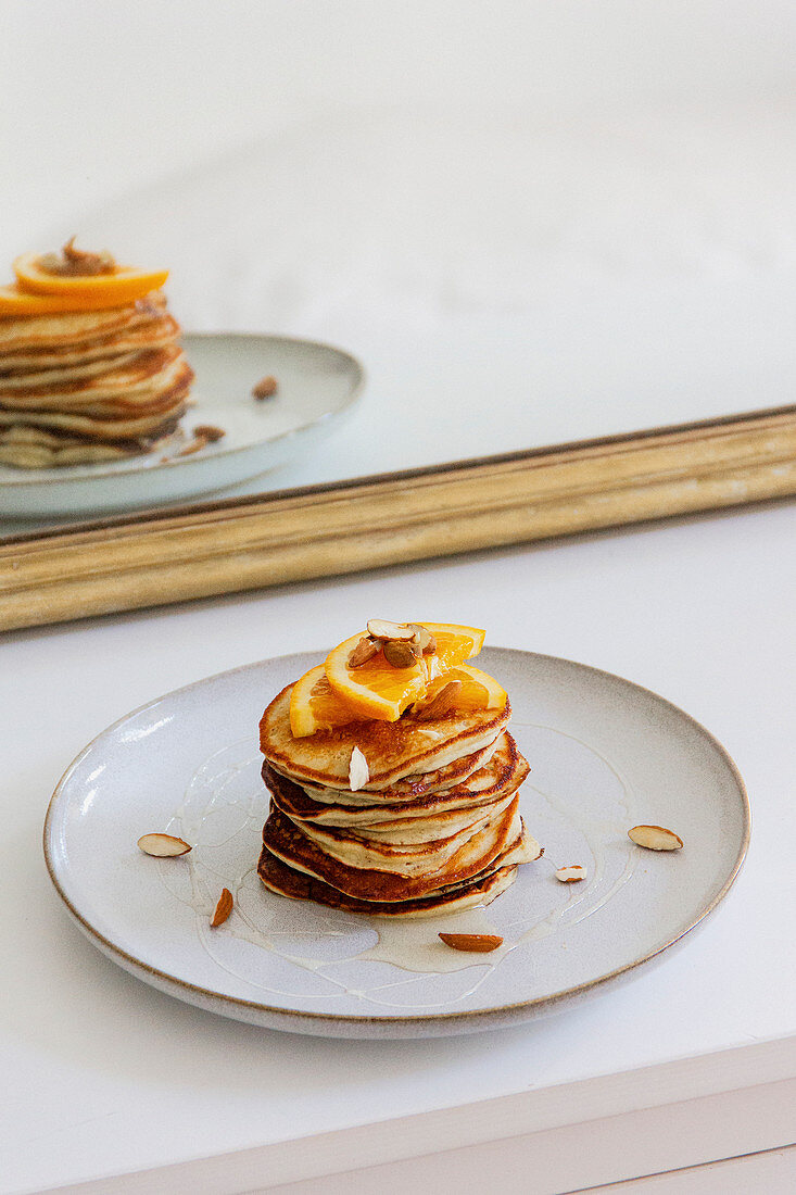 Fluffy banana pancakes with oranges and almonds