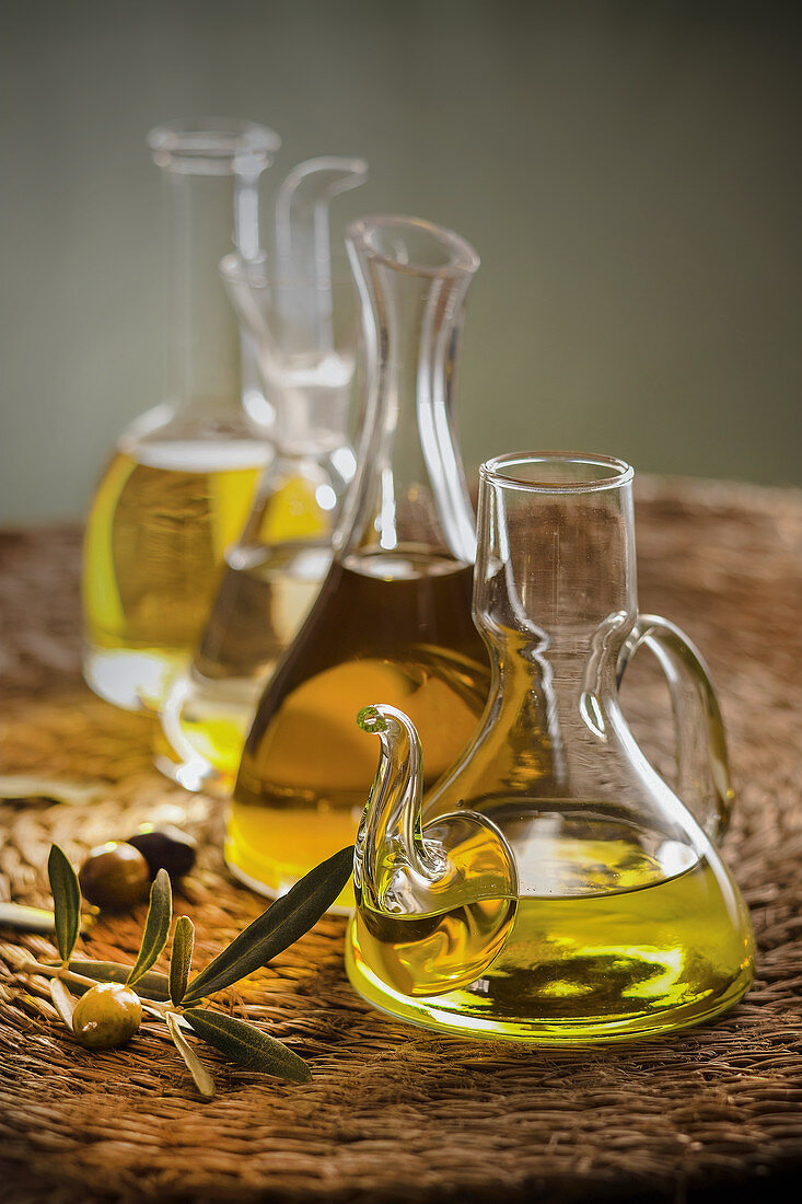 Different olive oils in glass carafes