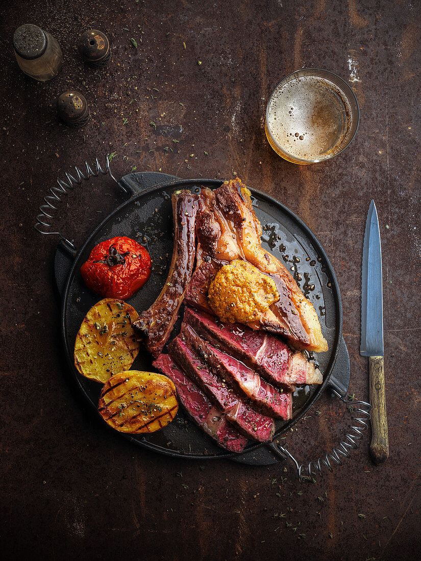 Grilled beef steak with roast potatoes and tomatoes