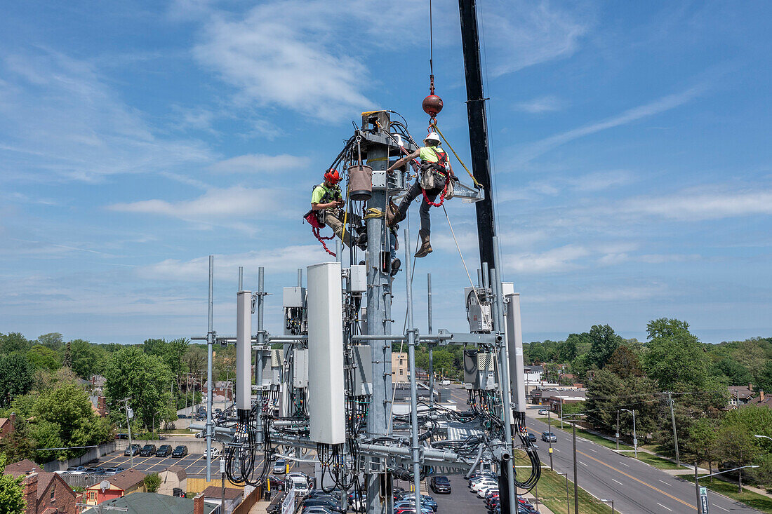 Workers upgrading a cell tower, aerial photograph