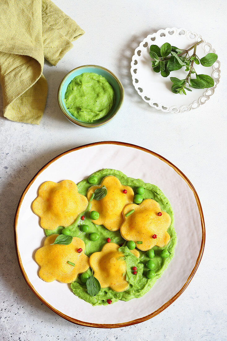 Saffron ravioli with ricotta and marjoram filling and pea sauce