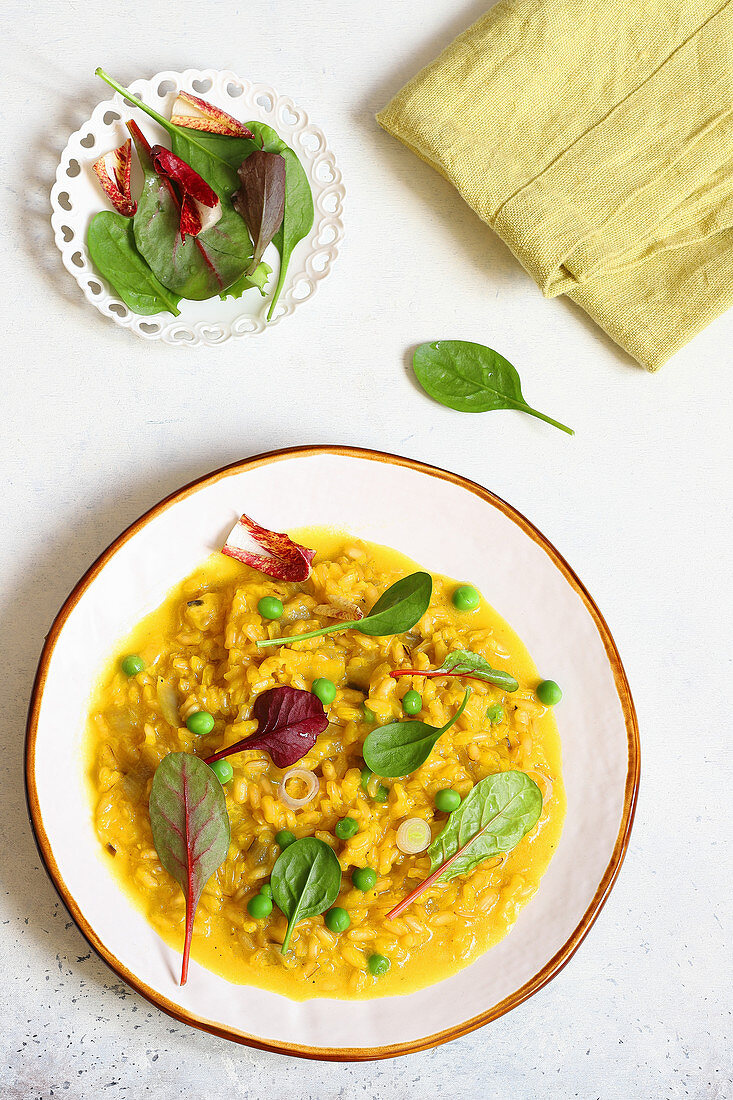Saffron risotto with fontina, peas and herbs