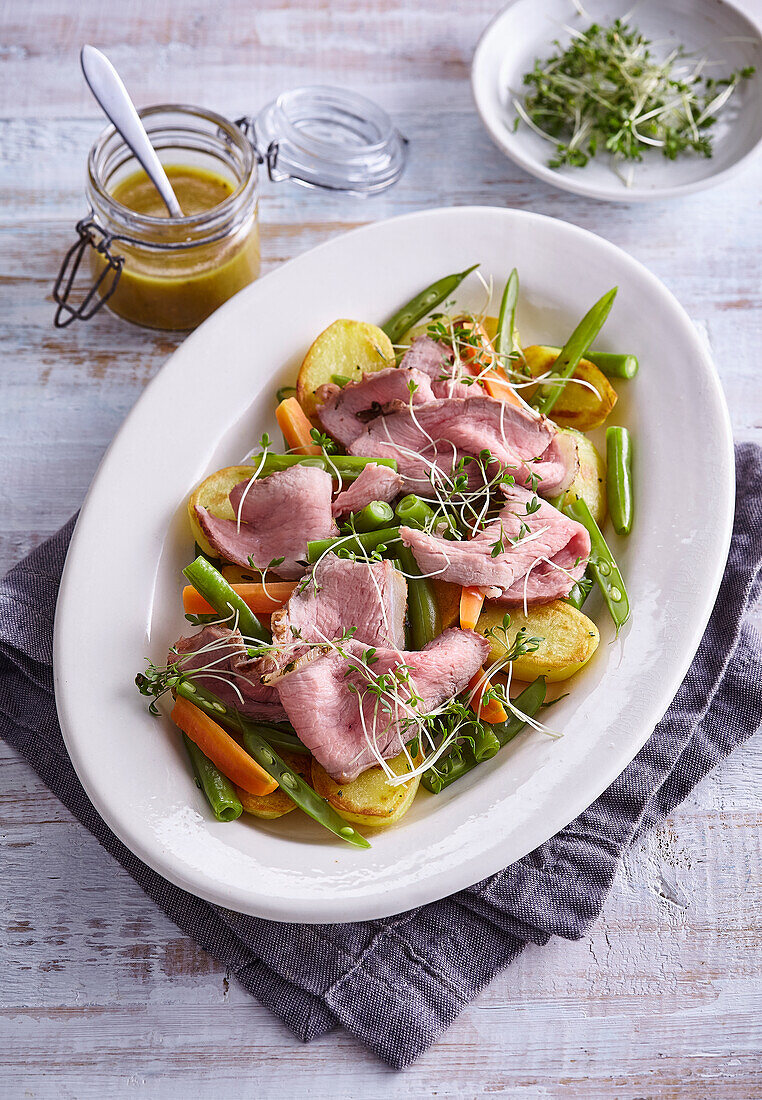 Roast veal with potatoes and vegetables
