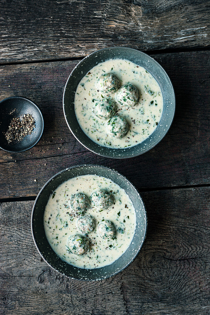 Creamy wild herb soup with spinach dumplings