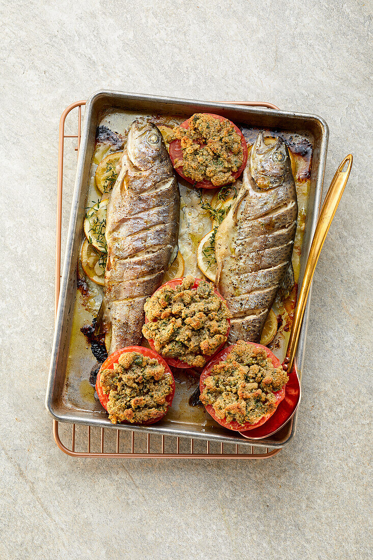Roast trout with stuffed herb tomatoes