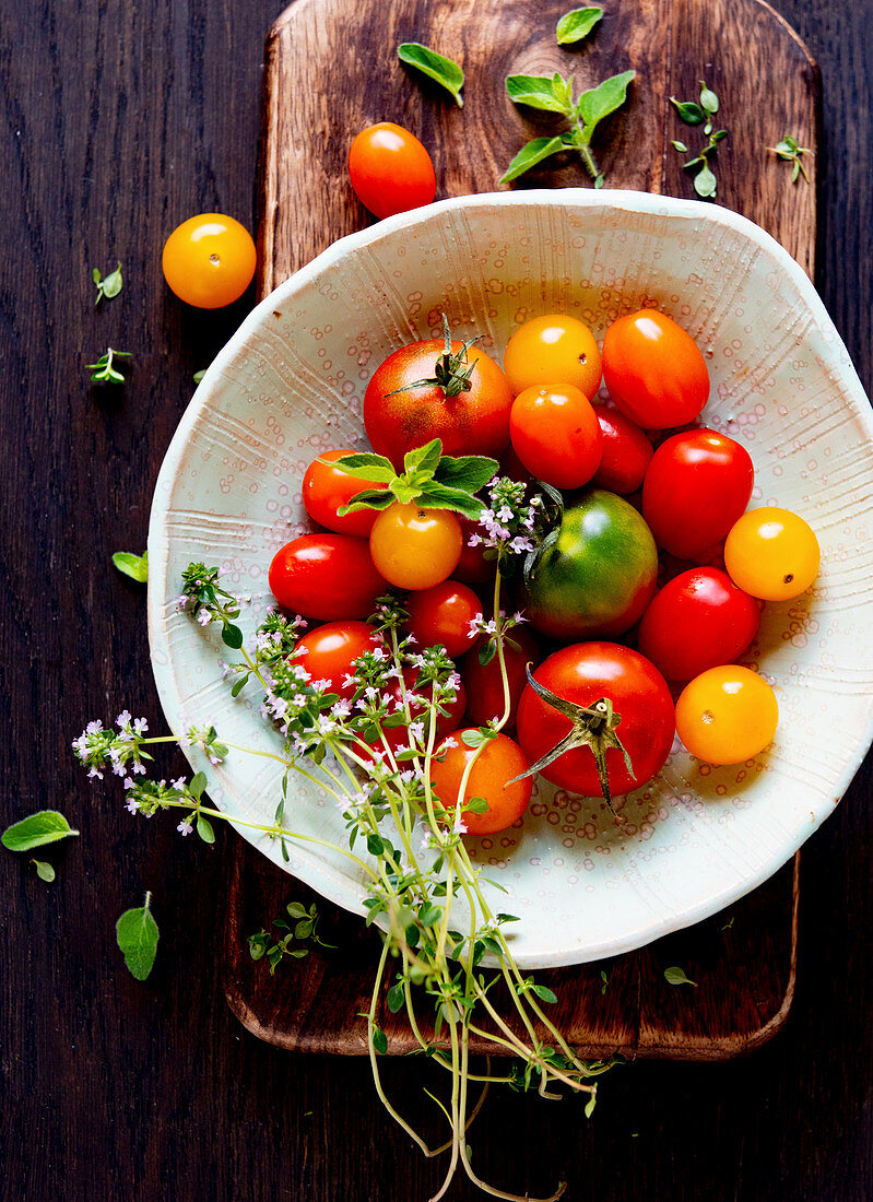 Fresh colorful tomatoes with thyme flowers