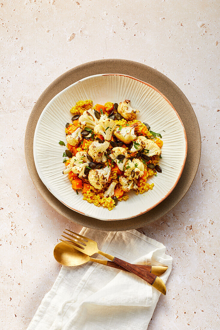 Vegan pumpkin-millet pilaf with roasted cauliflower