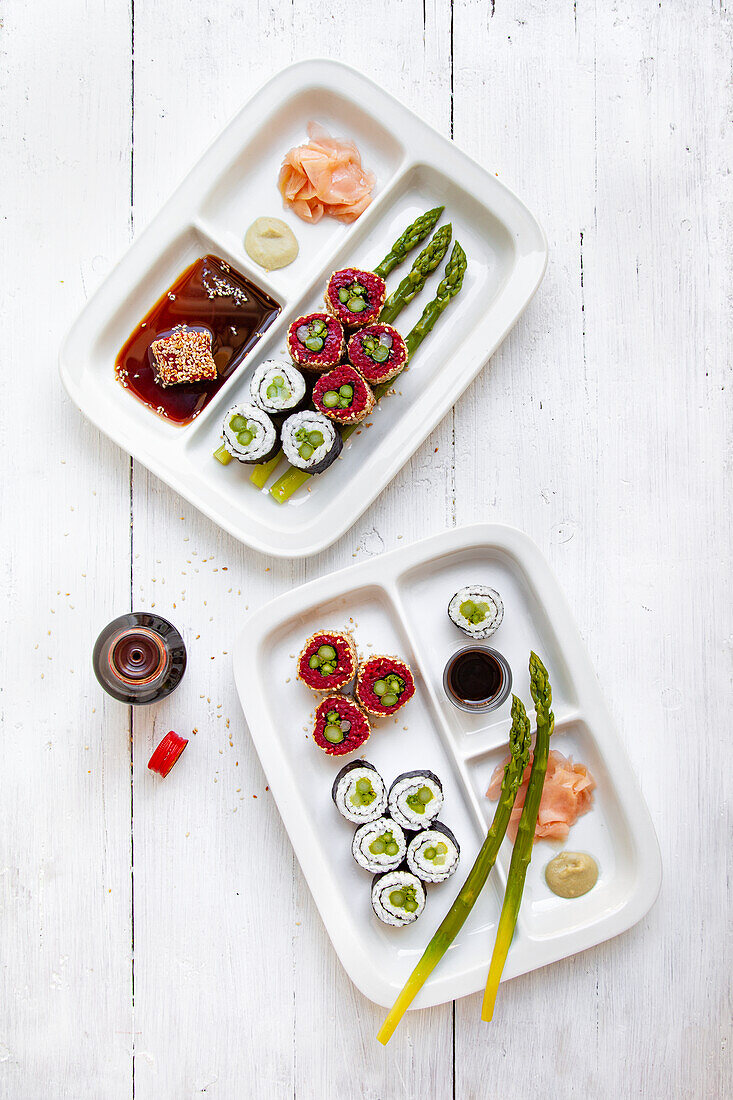 Bentobox Sushi platters with green asparagus and soy sauce