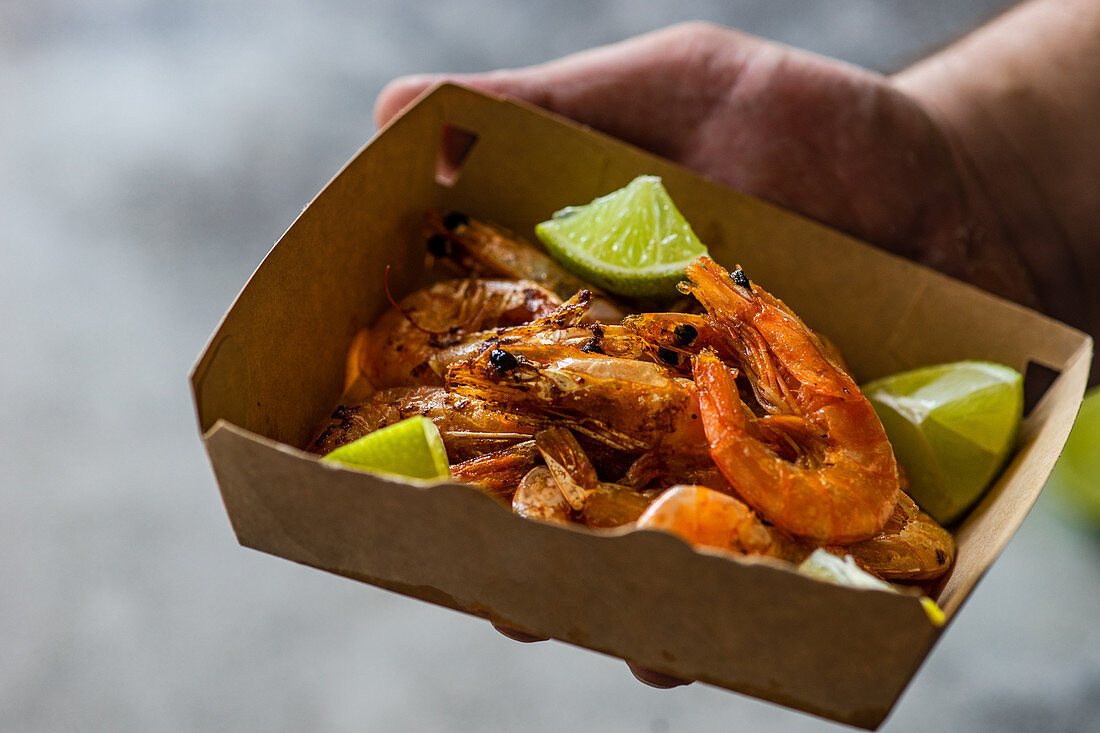 Gebratene Garnelen mit Limettenscheiben in der Fastfood-Lieferbox