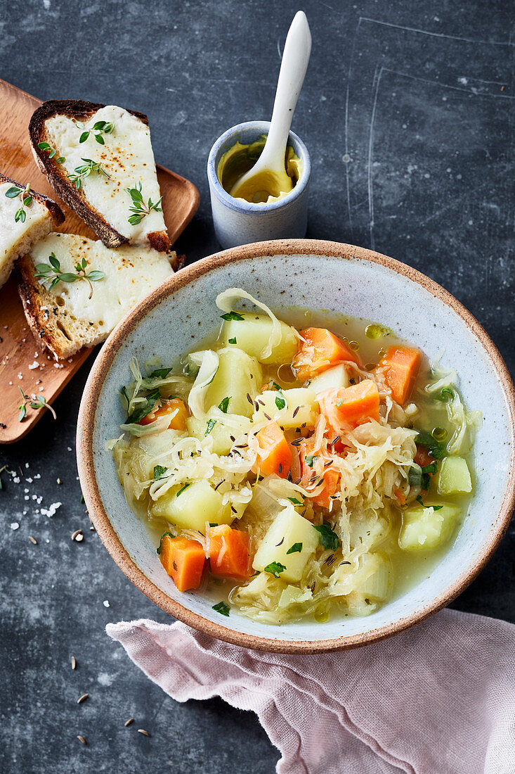 Sauerkraut-celery stew with raclette crostini