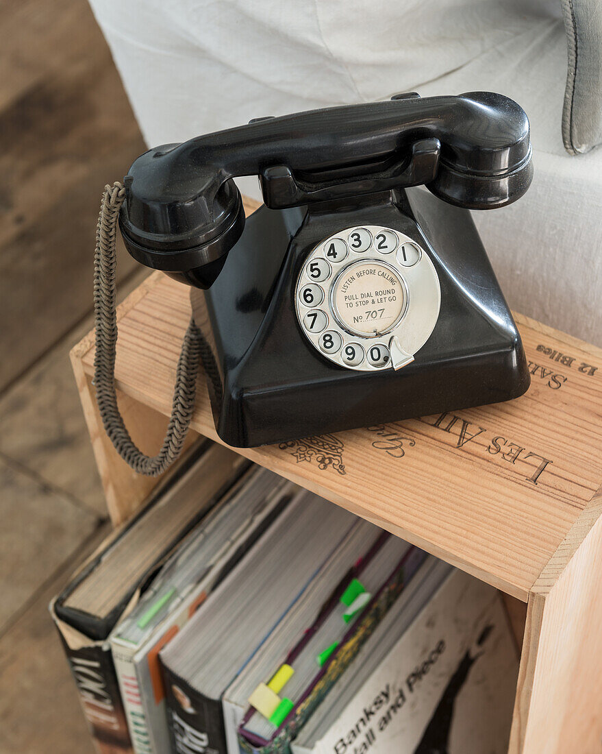 Telephone with dial on wine crate as side table