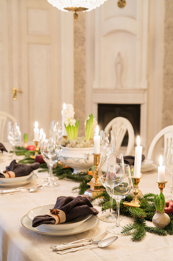 Festively laid Christmas table with wine glasses