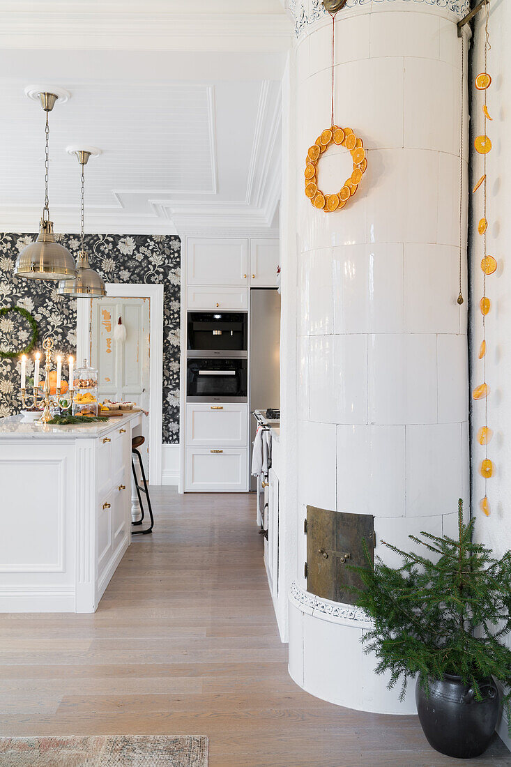 Tiled stove in open, white kitchen with kitchen island