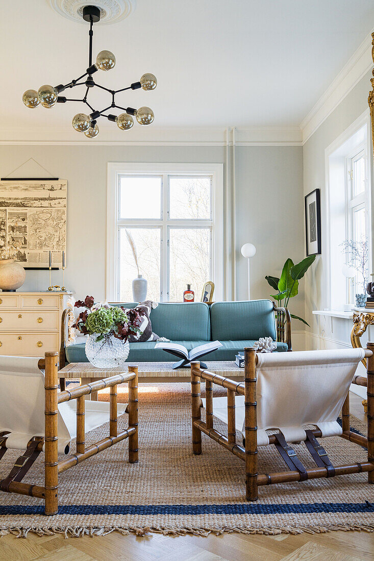 Living room with armchairs from the 70s and light blue upholstered sofa