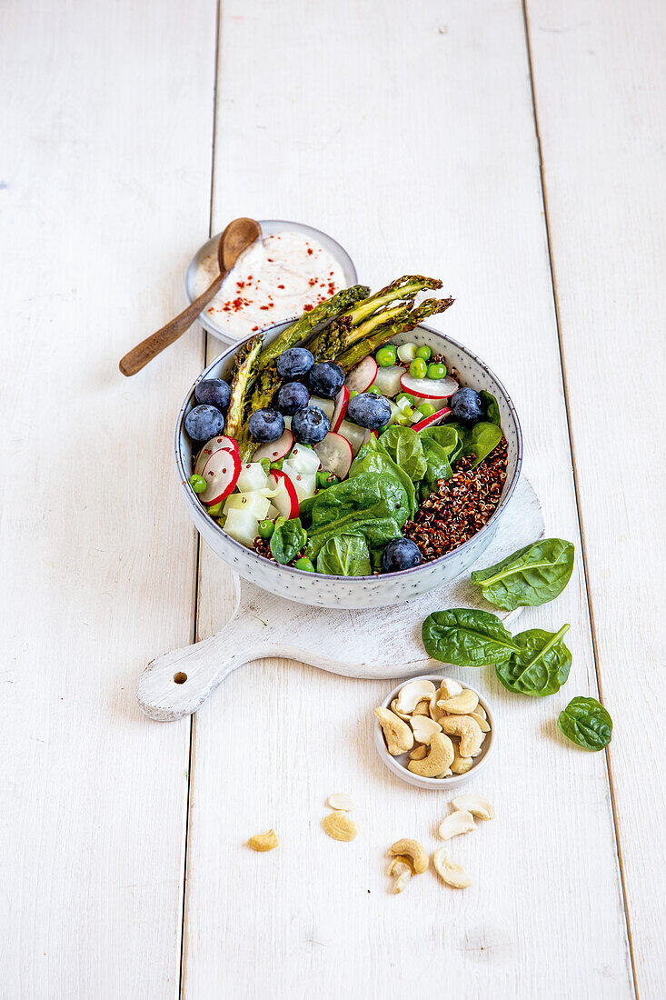 Quinoa bowl with green asparagus and blueberries