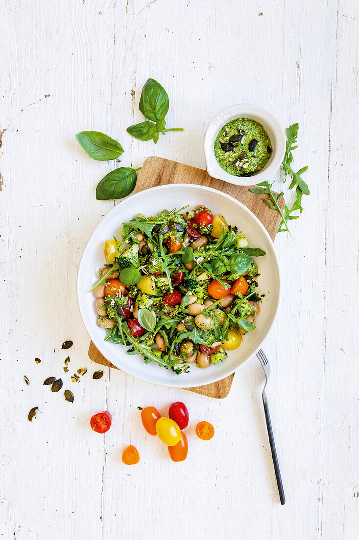 White bean salad with broccoli, tomatoes and basil and rocket salad