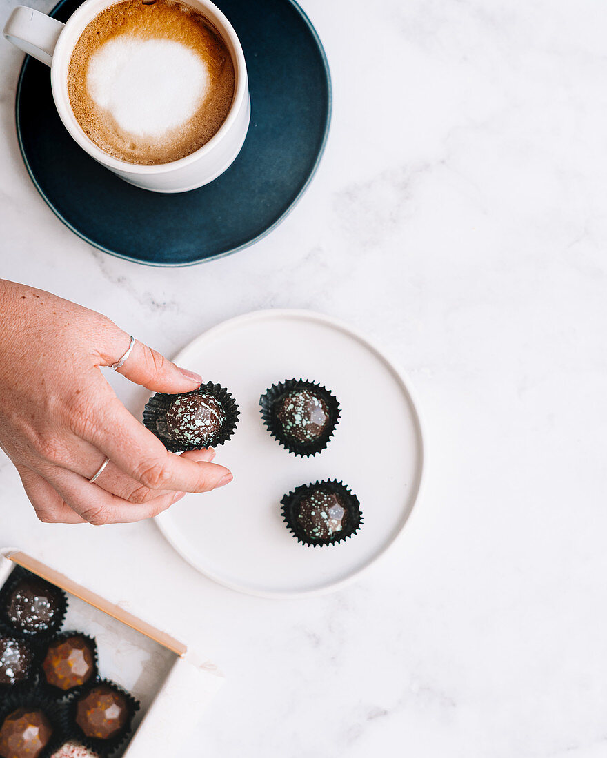 Chocolate bon bons with hand