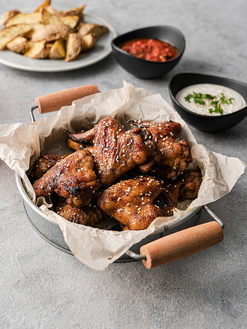 Chicken wings with dips and potatoe wedges