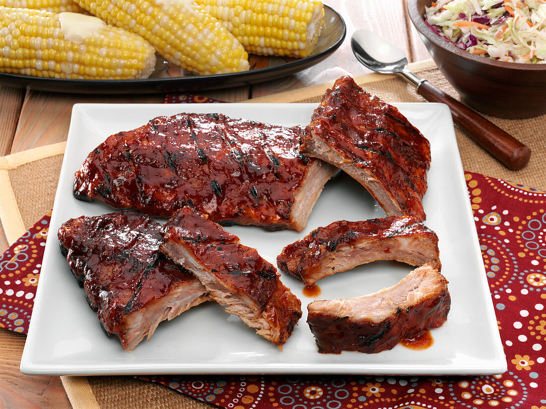 BBQ baby back pork ribs with corn on the cob and cole slaw