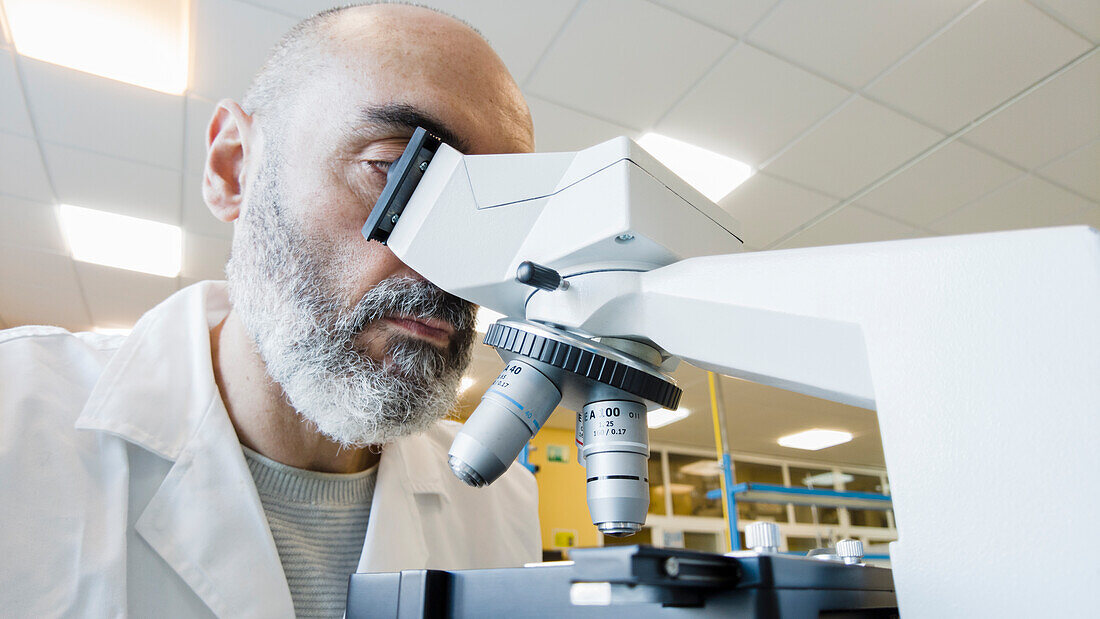 Scientist using a microscope