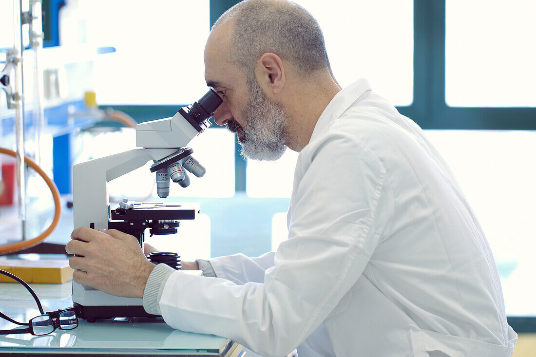 Scientist using a microscope in a laboratory