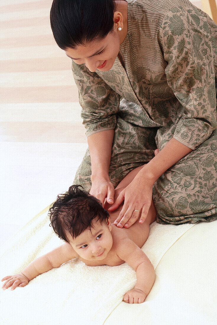Woman massaging baby